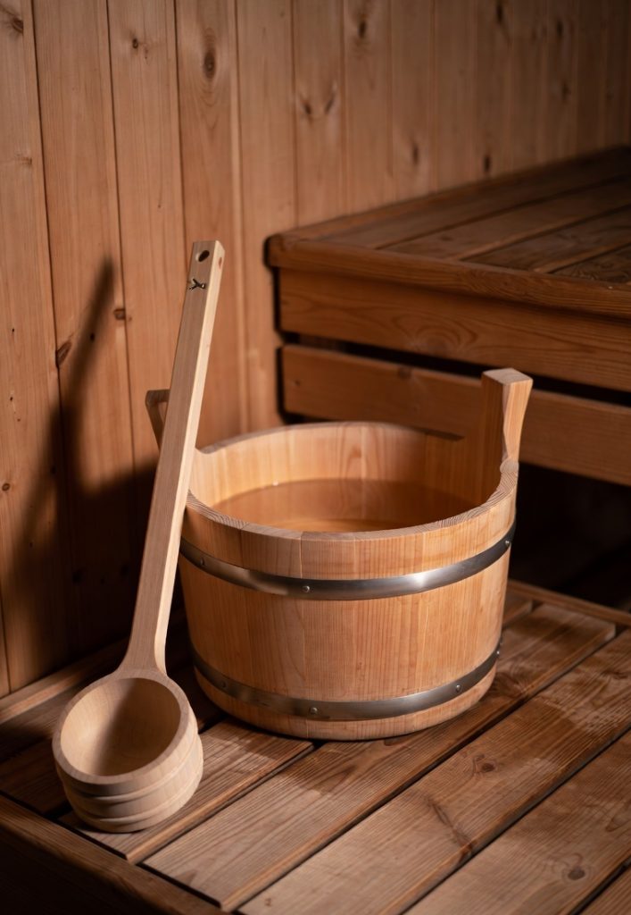 Finnish wooden sauna bucket with ladle for creating löyly – how to sauna guide